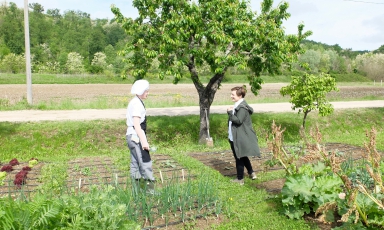Antonia Klugmann in the morning while she’s picking herbs and sprouts in front of L'Argine together with intern Emanuele Del Do, from San Daniele in Friuli
