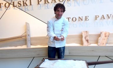 Tomaz Kavcic - chef at Pri Lojzetu in Zemono, half an hour’s drive from the Italian border – here at the entrance of his country’s pavilion, Slovenia. Using his hands the chef filters salt crystals from Piran, one of the country’s most important symbols