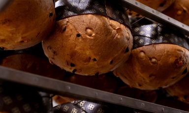 Una volta cotti, i panettoni vengono capovolti così da trattenere l'umidità all'interno del pirottino, assicurando stabilità e sostegno alla struttura: un passaggio cruciale nel processo produttivo dei panettoni eseguito manualmente con estrema rapidità. Anche questo è l'artigianato organizzato di Oliveri 1882
