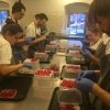 Interns roll the radish roses together, on the top floor at Noma. Loud music and teamwork help making the job less alienating
