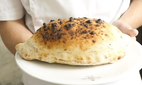 Franco Pepe’s calzone with prickly lettuce. He i