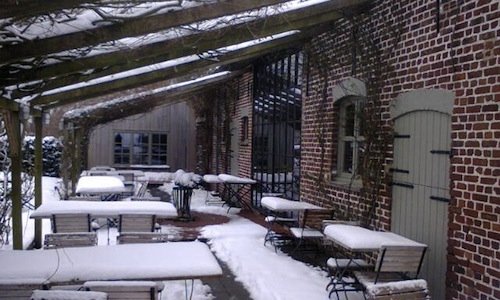 The snowy exterior of the In De Wulf restaurant, i