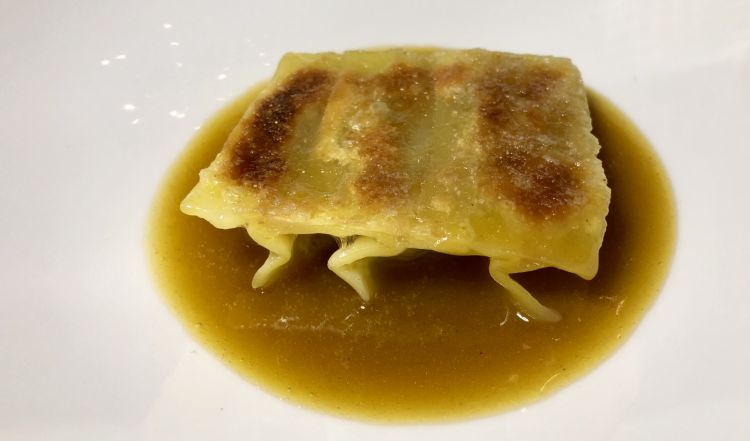 DISH NUMBER ONE. Chinese dumpling filled with roasted potatoes between a guinea fowl "bisque" and a Parmigiano brittle 

