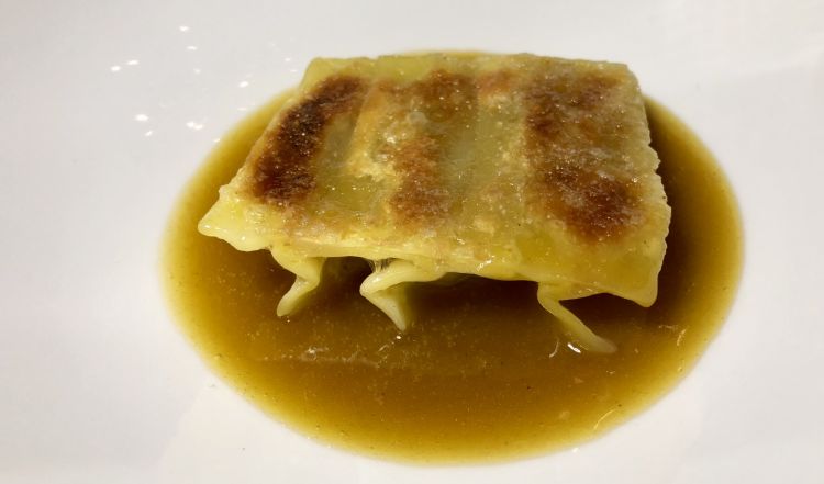 DISH NUMBER ONE. Chinese dumpling filled with roasted potatoes between a guinea fowl "bisque" and a Parmigiano brittle 
