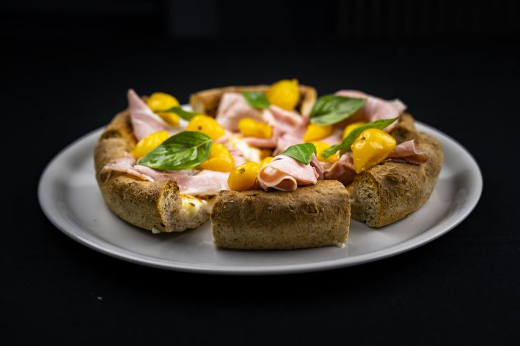 Pizza in the pan with yellow cherry tomatoes, prosciutto cotto selezione Branchi, smoked provola and caramelised onion