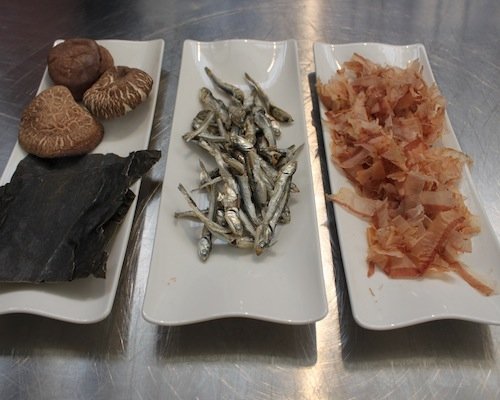 Dashi's components. Left to right: shiitake mushrooms and kombu seaweeds, niboshi and katsuobushi