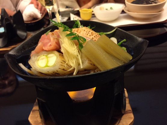 Sukiyaki (saucepan on a flame) with chicken, onion, vegetables and mirin (sweet saké)
