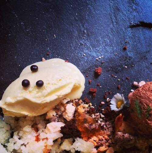 Chocolate mousse on a bed of almonds and crumbled meringues, served with vanilla ice-cream, lemon granita and dill