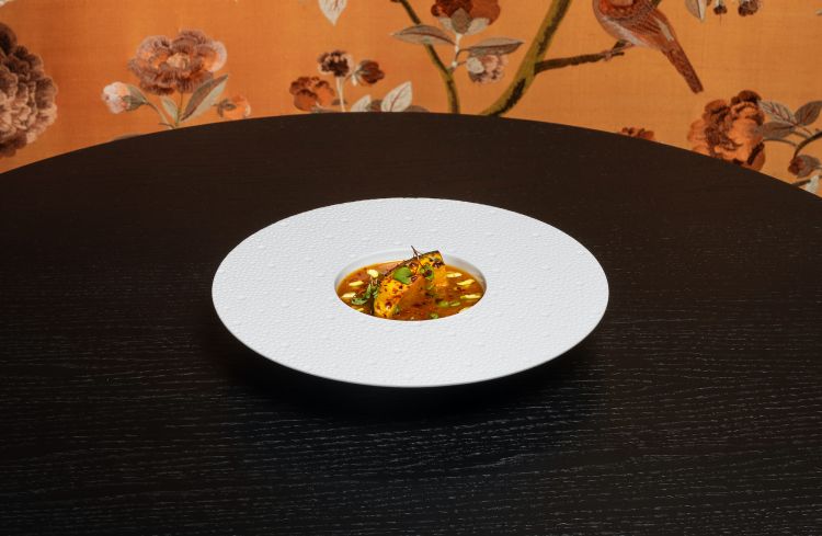 Zucca speziata: cotta prima in cartoccio, scottata poi alla brace, viene accompagnata con estratto di zucca, polpa d’arancia, pistacchio sia in crema che a lamelle, grani di senape. Viene condita infine con Harissa (un blend di spezie nordafricane), che le danno un kick notevole, che persiste a lungo nel palato, facendo capire come un piatto tutto vegetale possa essere potentissimo. (foto Omnigraf Italia)