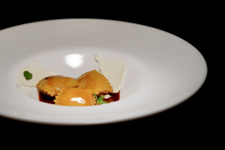 Raviolo di coniglio, prugna e brus: un raviolo “del plin” ripieno di coniglio, servito su un fondo ristretto di coniglio e prugna. Sul bordo del piatto viene spalmato il brus, ricotta di pecora fermentata della tradizione ligure: il raviolo va mangiato uno alla volta, trascinandolo nel fondo e raccogliendo anche il formaggio, quasi facendo la scarpetta direttamente nel piatto
