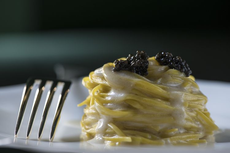 Homemade fresh pasta tagliolini with Carnia butter sauce with anchovies, lemon and caviar, one of Airaudo's classics
