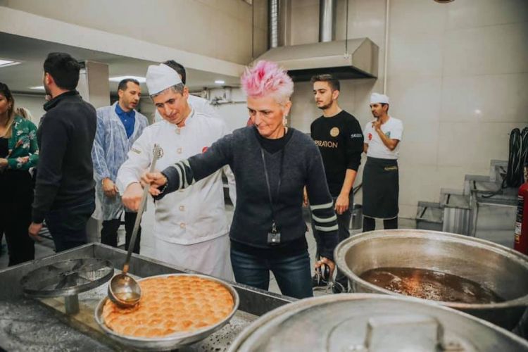 Bowerman, before the congress, making baklava
