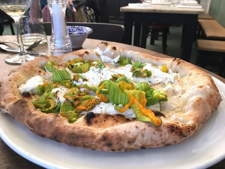 Pizza Lazzarella from Guglielmo Vuolo in Florence, with cow’s milk ricotta, provola di Agerola, courgette flowers, salt and pepper 
