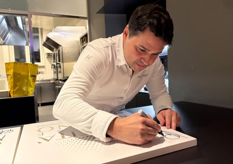 Lo chef di Da Terra lascia la sua firma sul cartellone celebrativo dell'hub