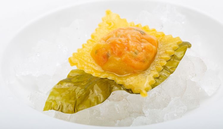 Raviolo stuffed with salmon Ora King in a vegetable broth 
