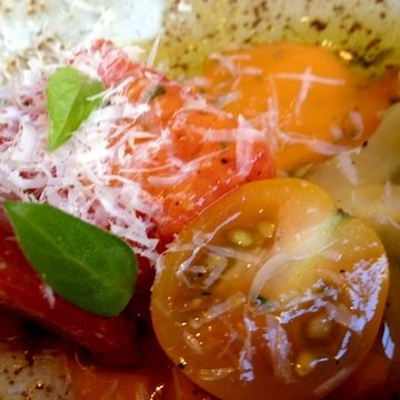 Tomato salad with tomato sauce emulsion and olive oil at Husk Restaurant brunch. Extravirgin oil is a Texas product