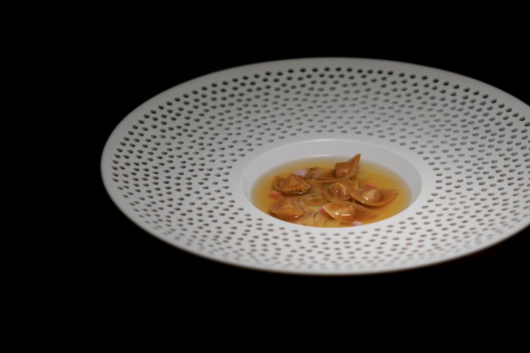 Tortelli di pane, brodo di gallina e canocchia. Il brodo di gallina &egrave; armonizzato con mela, finocchietto, scorza d'arancia, alghe, rape, &laquo;&egrave; l'inverno&raquo;. Il ripieno &egrave; di pane grigliato, la canocchia cruda. Grande armonia e un qualcosa di irrisolto
