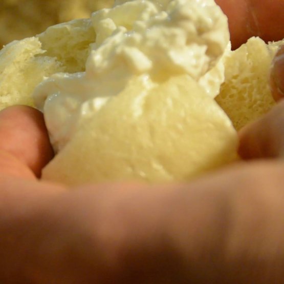 Bread made with mother yeast and cheese, held in the hands of Renato Bosco