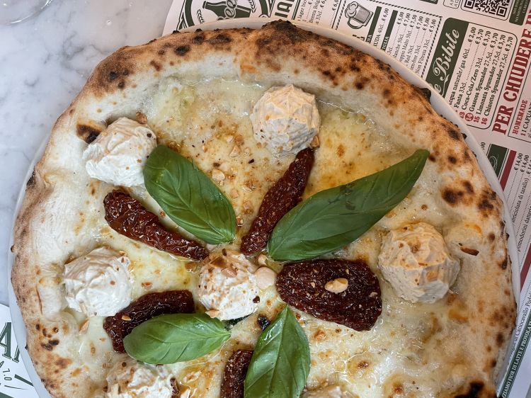 La pizza Bronte con provola affumicata, pomodori secchi, crema di ricotta al pistacchio di Bronte e mandorle