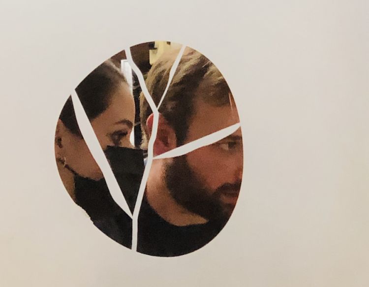 Alice Vannicola and Carlo Sebastiani behind the door that separates the dining room from the kitchen at da Sebastiani in Ortezzano in the Marche