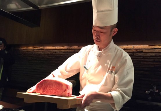 The chef at restaurant Kobe Plaisir in Kobe holds 