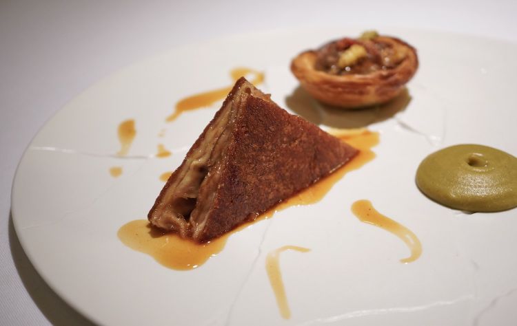 Crunchy suckling pig, pepper sauce, broad been purée, savoury pastel de nata with wild strawberries and cinnamon (2020). The savoury pastel de nata is made with pig entrails 
