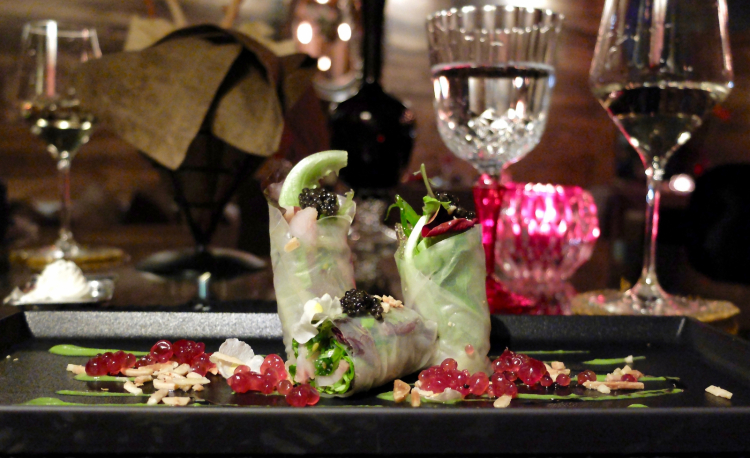Slightly smoked sturgeon wrapped in rice paper with cream of broccoli, pomegranate gelatine and toasted almonds 
