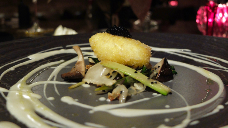 Breaded poached egg fried with vegetables and sesame and a fondue of Parmigiano, pearls of truffle 
