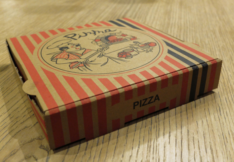 A pizza carton box is served...
