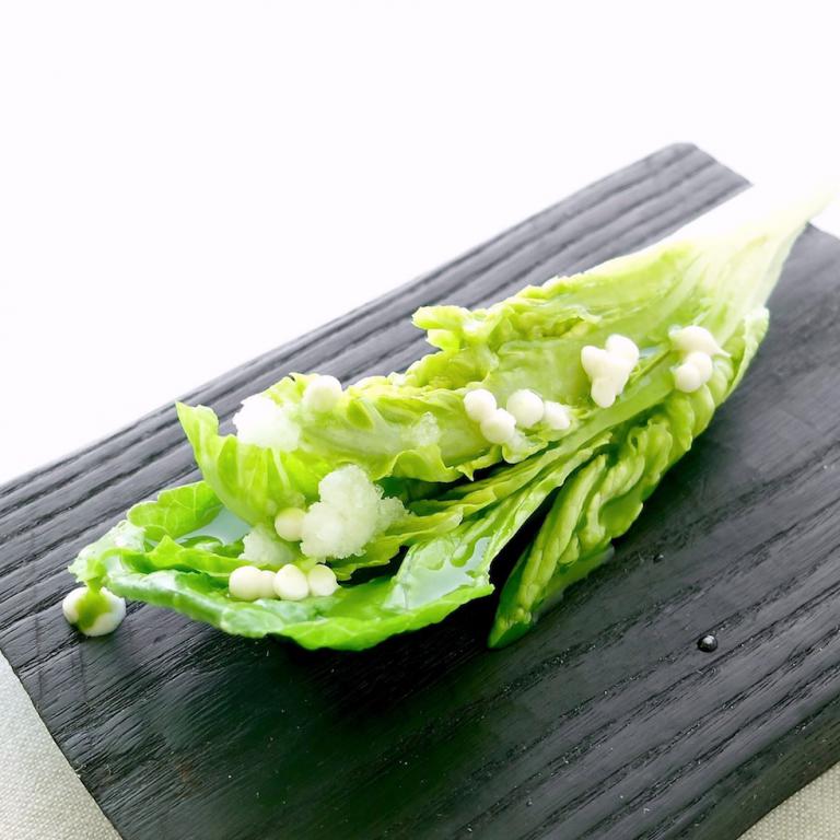 Heart of lettuce, juice of salpicón vegetables and almonds. Salpicón is a sort of typical salad made with diced vegetables, with lots of variations, including some with meat 
