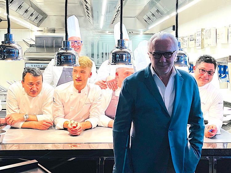 Left to right, Alain Ducasse posing in front of th