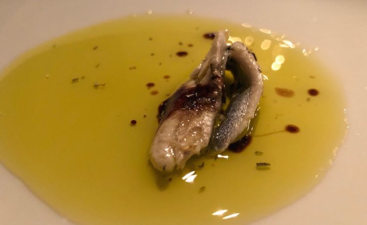 Amuse bouche: Anchovy filet, extra virgin olive oil, Slovenian salt flakes from Pirano and cream of vinegar 
