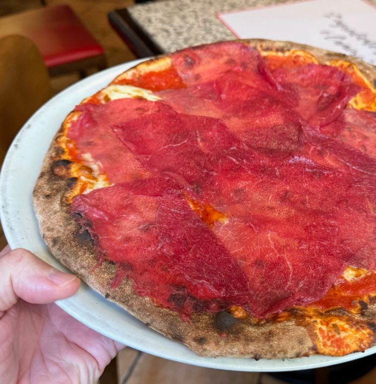 La pizza con carpaccio di manzo, rucola e scaglie di grana de Il Commercio