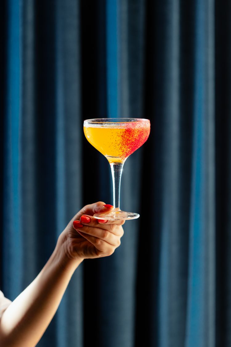 French Bulldog, un twist sullo champagne cocktail proposto da Fabrizio Valeriani, il bar manager de Il Marchese, a base di gin, Amaro Gagà, succo di lime, Franciacorta Freccianera F.lli Berlucchi e polvere di lampone disidratato a decorazione e completamento del drink.