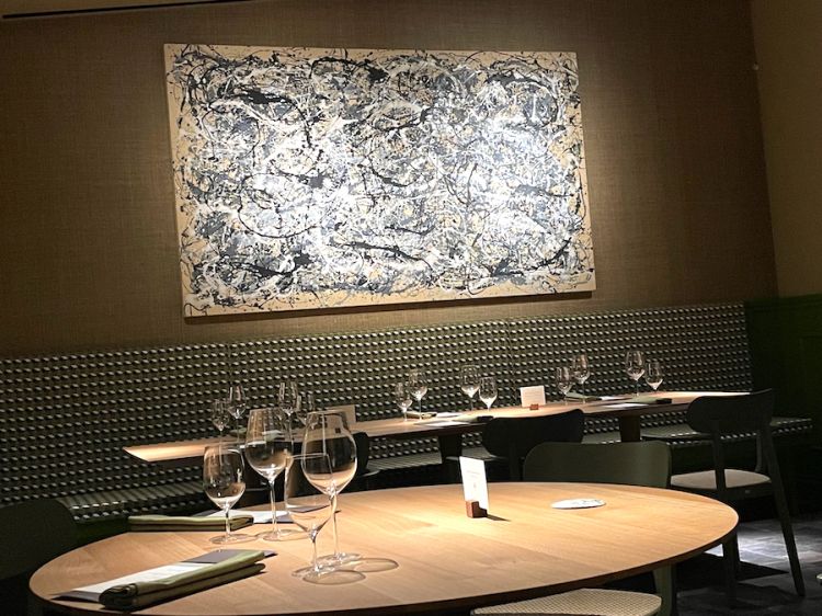 The painting on the wall at the end of Gatto Verde's dining room is by Mike Bidlo, an artist who plays on the truth of his art forgeries such as this Not Pollock
