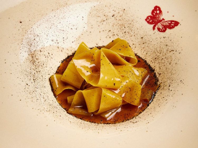 Pappardelle al cinghiale: pasta ruvida, fondo scuro e polvere di arancia bruciata