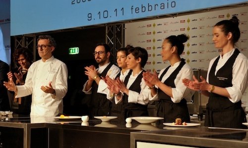 Massimo Bottura and the six young women working at
