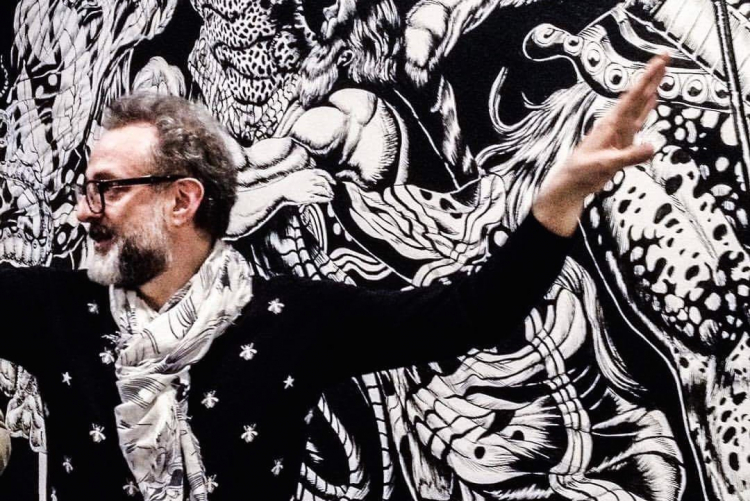 Massimo Bottura in front of the mural project to 