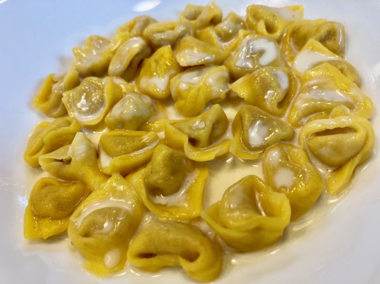 Tortellini half in broth and half in cream prepared at Refettorio for around one hundred guests. They all asked for a second helping 
