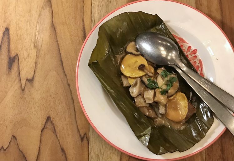 Tamal with plantain maduro and mushrooms. Tamales are a typical dish in some Latin American cultures: rolls made with cornflour dough, filled with meat vegetables etcetera
