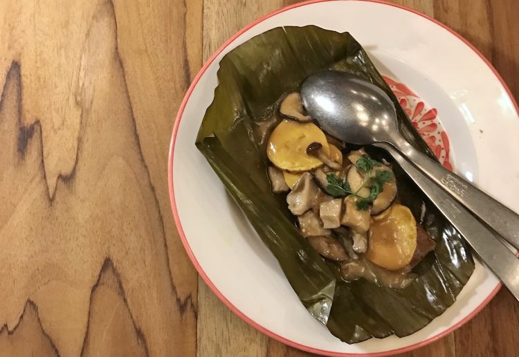 Tamal with plantain maduro and mushrooms. Tamales are a typical dish in some Latin American cultures: rolls made with cornflour dough, filled with meat vegetables etcetera