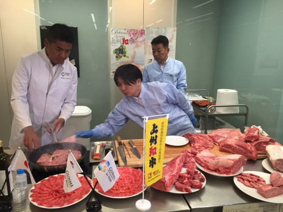 Nobuya Niimori, Japanese chef at Milanese restaurant Sushi B, with Makoto Hasegawa and Hiromitsu Matsuoka, director and assistant section manager at the Gunma Meat Wholesales Market, with the cuts of wagyu beef
