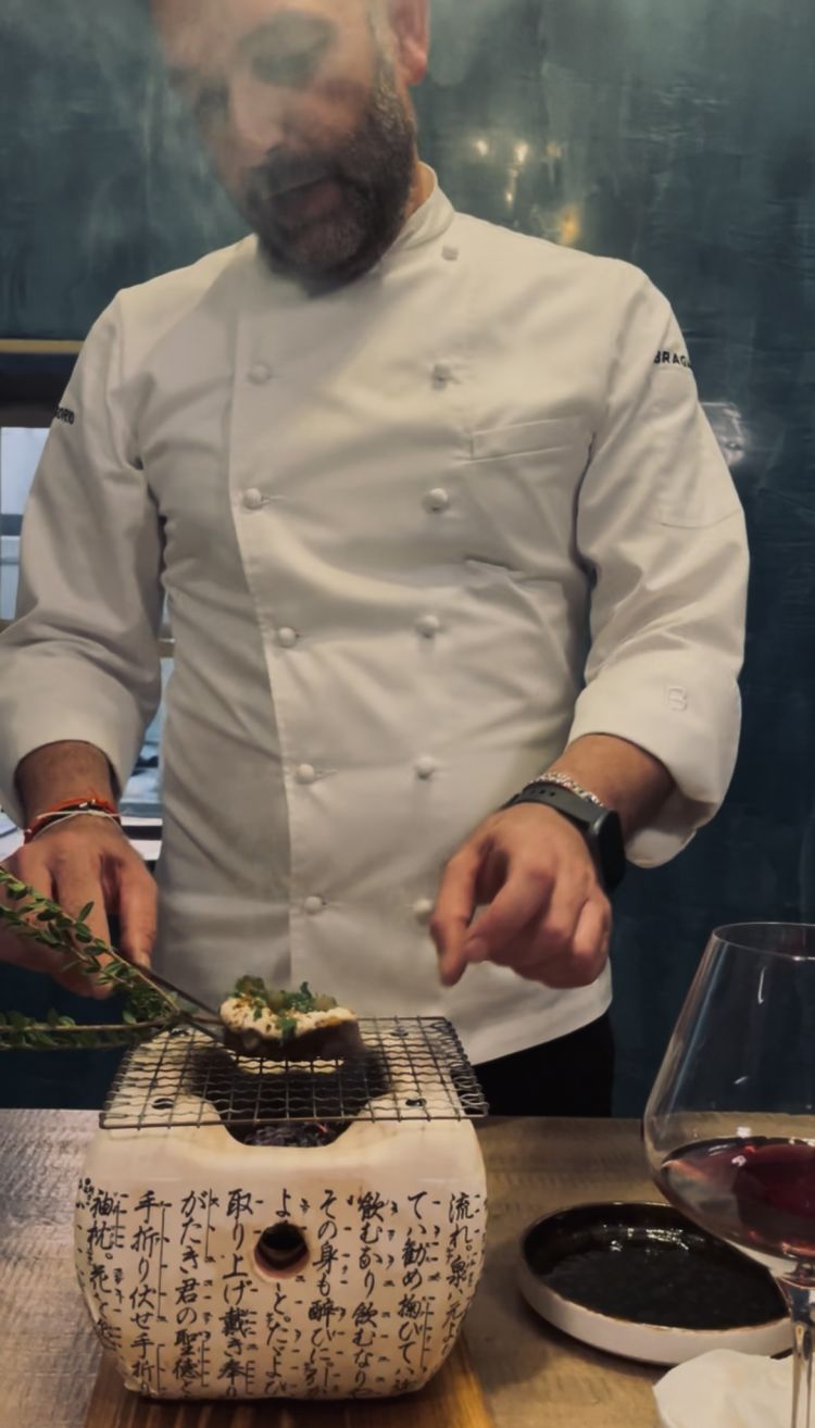 Agnello e il Mediterraneo in preparazione
Agnello cotto nel fieno, facussa, albicocca fermentata, hummus di ceci e pane Bazlama.

Un piatto complesso, che meglio delinea l'abbraccio del bacino mediterraneo e dei suoi popoli, dei suoi sapori: partiamo da una carne con la quale Stefano cresce, da molisana quale è la sua famiglia. Il nonno lo cuoceva nel fieno, vale a dire nell'alimento prediletto dall'agnello stesso, preferibilmente alla brace. Viene condito con albicocca fermentata fatta in casa (Turchia) con origano e zahatar, maionese al peperoncino di Aleppo (Siria), coriandolo, facussa fermentata (Marocco). L'agnello viene poi irrorato con del fondo bruno speziato e un olio aromatizzato all'alloro, e servito con hummus di ceci e pane Bazlama (ancora una volta Turchia), morbidissimo, appena lievitato
