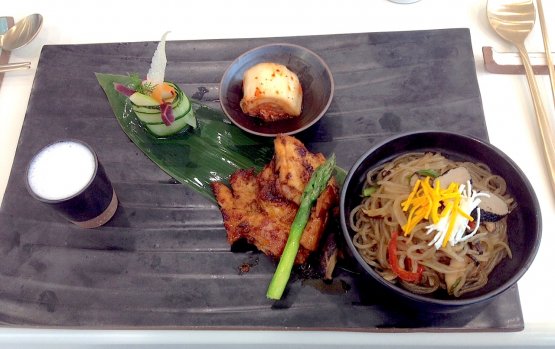 Inside the restaurant of Korea’s pavilion you can find specialties such as Bibimmyeon & kimchi soban, a slate picture which includes, clockwise, mushroom porridge (in the small glass), salad, kimchi (fermented cabbage), Korean noodles with white kimchi (bibimmyeon) and grilled chicken in soy sauce