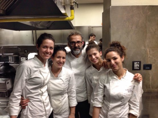 In the kitchen of Osteria Francescana, Massimo Bottura with four of the girls in his team 
