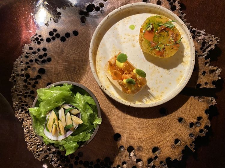 Left Clams, fermented cooking water from pasta, oil with sea weeds and sea fennel. Right Taco with polenta, schie, egg sauce with lemon, oil with peperone crusco, Mexican oregano & Drop of gold, oil of celery leaves, sea urchins, Venetian curry