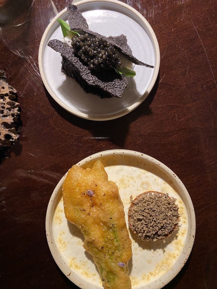 Above: creamed cod with koji, rice waffles with squid ink, oyster leaf, caviar.  Below: courgette flower tempura, coffee, lavender & porcini mushroom tartlet, almonds, black truffle