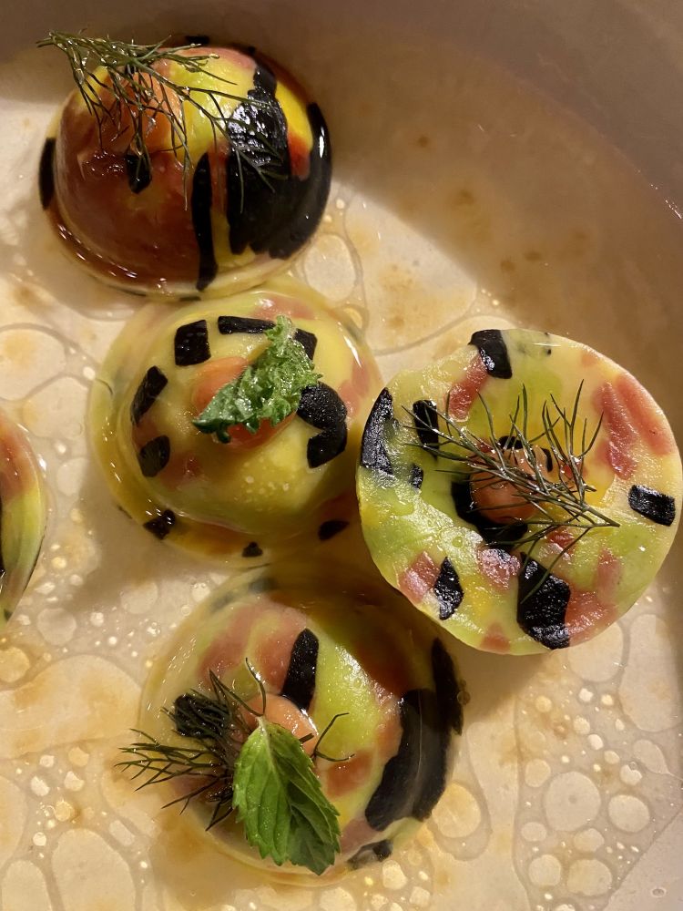 Ravioli filled with cod tripe, broth of busara and spiced oil
