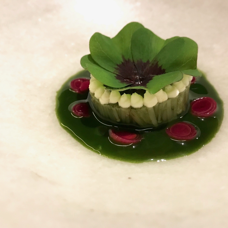 A beautiful dish, Esponja de enoki, a sponge of roots from the enoki mushrooms with green onions, beetroot and seaweed 
