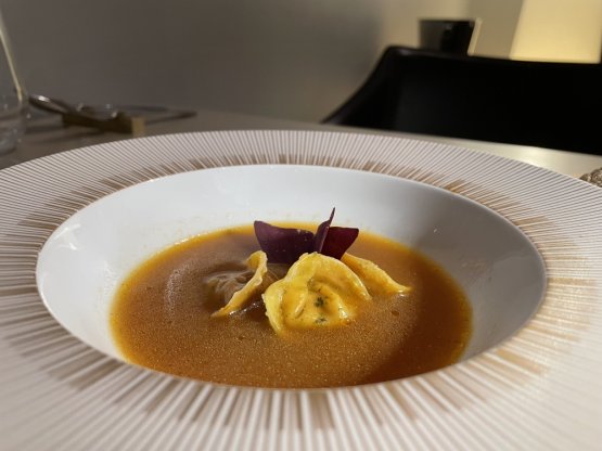 Soup – Chicken Ravioli, broth of lentils and tomato 
Essence of tomato di pomodoro cooked with lentils from black lentils fermented with cloves, cardamom, fenugreek and coriander seeds, served with chicken ravioli

